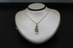 FS1002: 10k 0.10 ct TW diamond treble clef pendant with box chain.